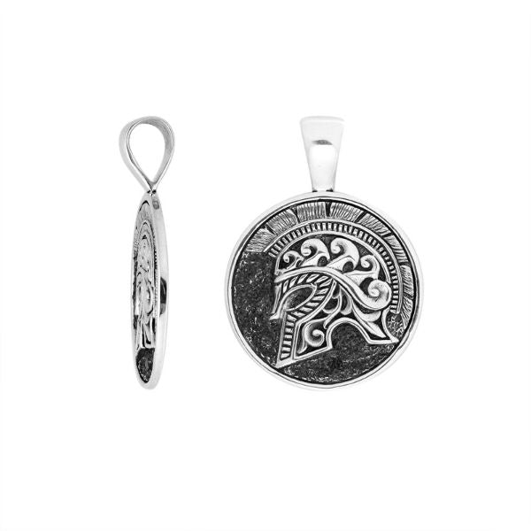 Artistic round sterling silver pendant featuring an engraved warrior helmet motif with textured detailing and polished edges for a bold modern jewelry style