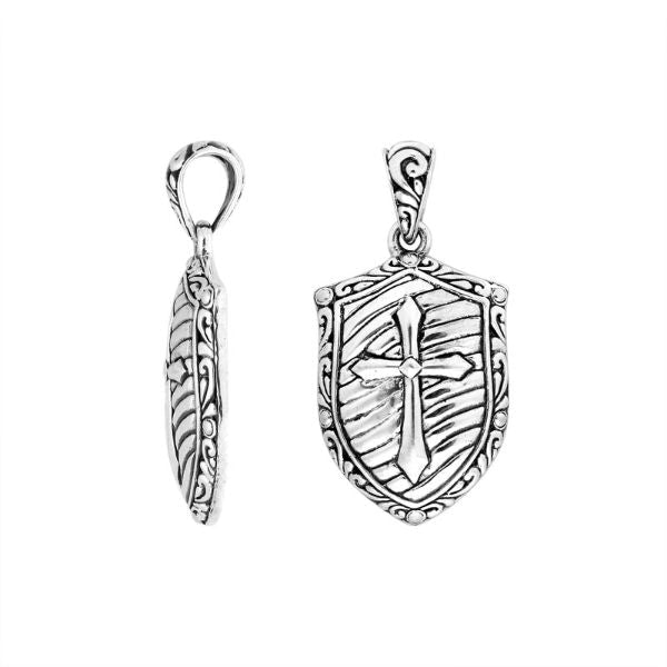 Artistic sterling silver shield pendant featuring an engraved cross design with textured background, polished borders, and expressive handcrafted-inspired detailing for modern jewelry lovers