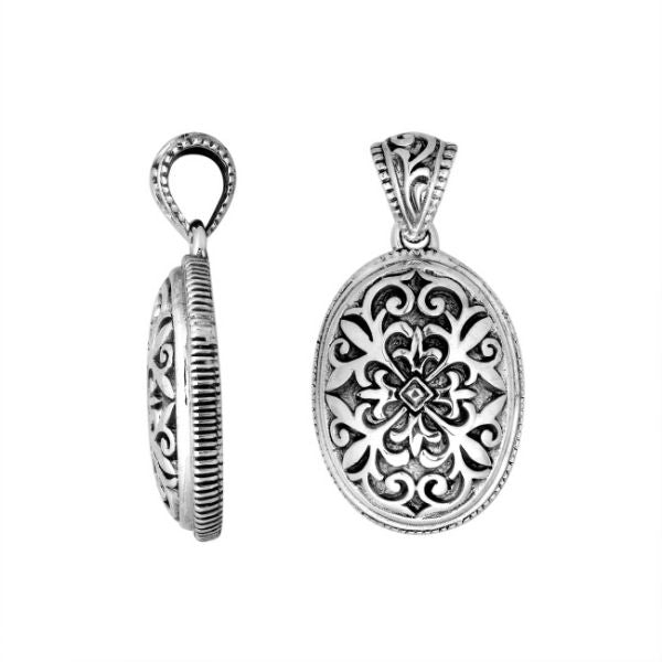 Artistic sterling silver oval pendant with floral carved motif.