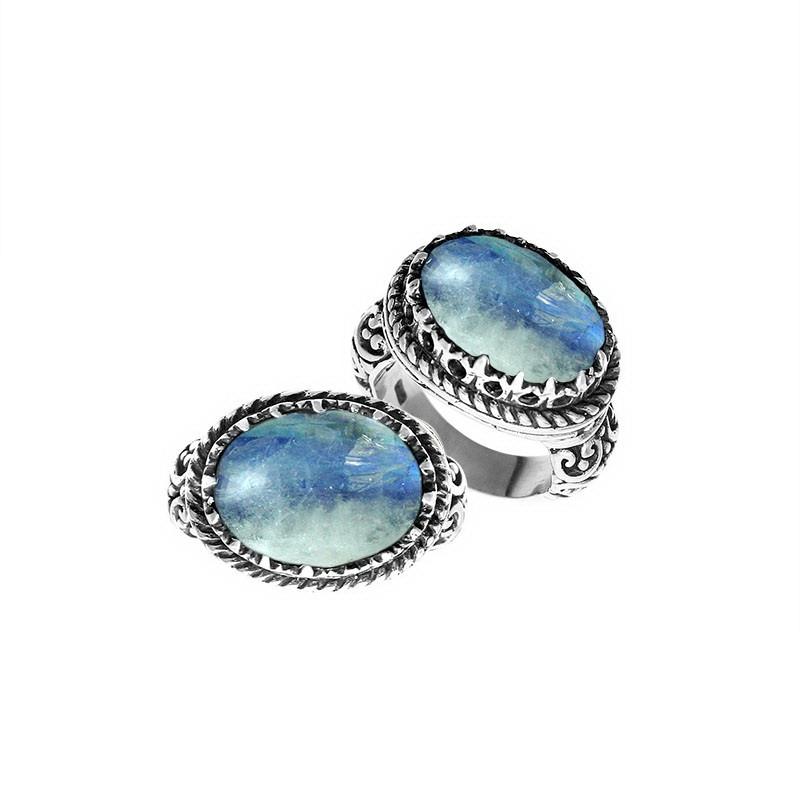 Handcrafted Bali sterling silver ring with oval Rainbow Moonstone, Blue Quartz, and ornate scroll design for retail customers.