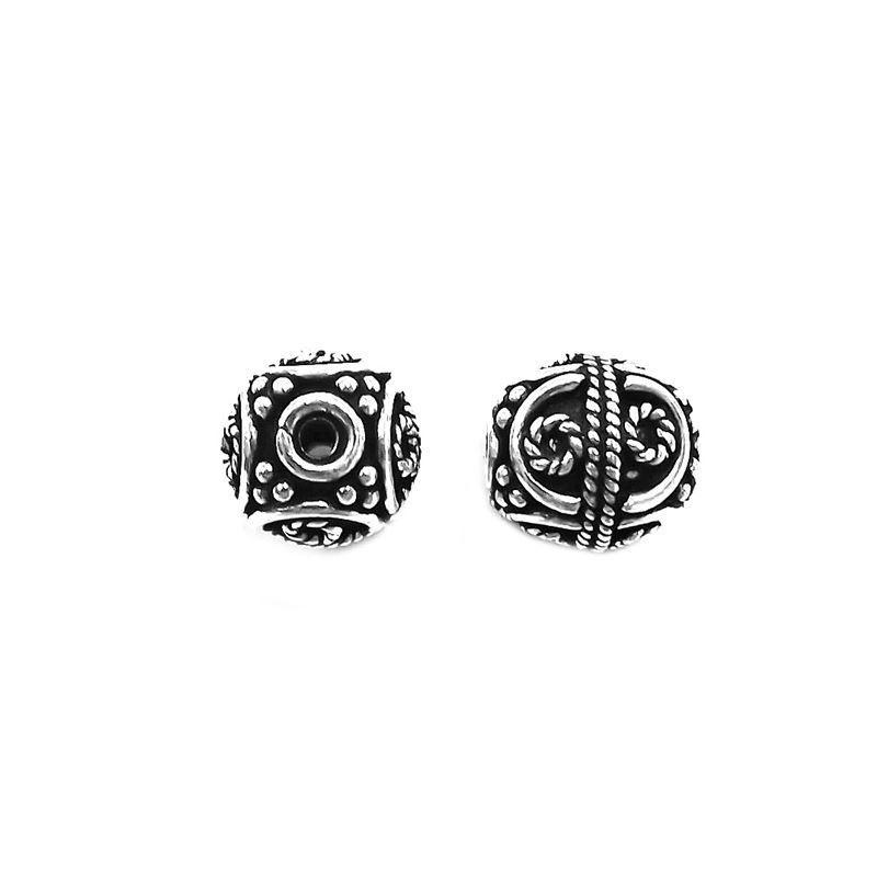 Artisan silver overlay over copper round bead with spiral scroll design, handcrafted in India for jewelry making.