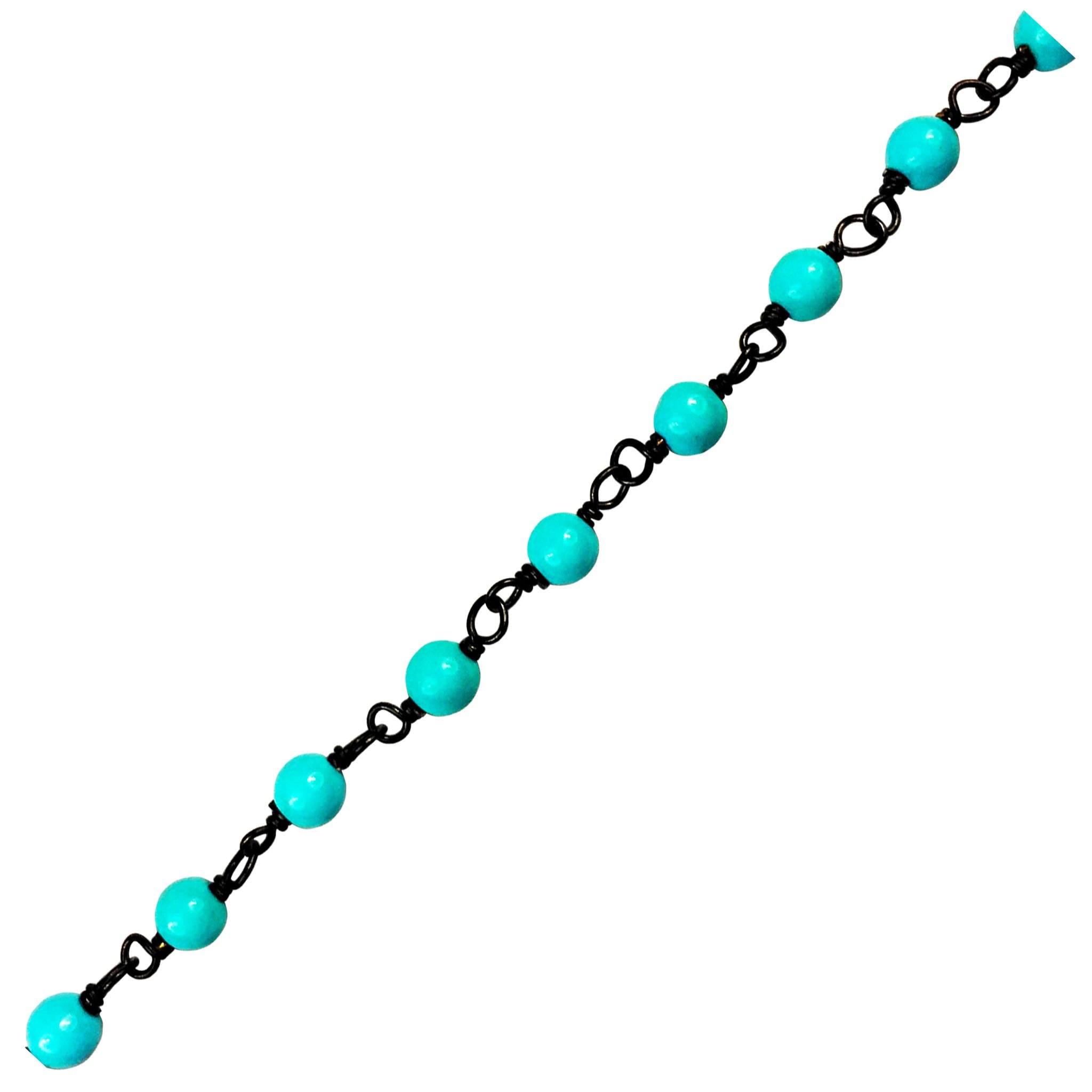 Oval link chain made with Rhodium Overlay Over Copper featuring Turquoise Shell bead accents, smooth polished dark finish, and flexible length sold per foot for custom jewelry styling
