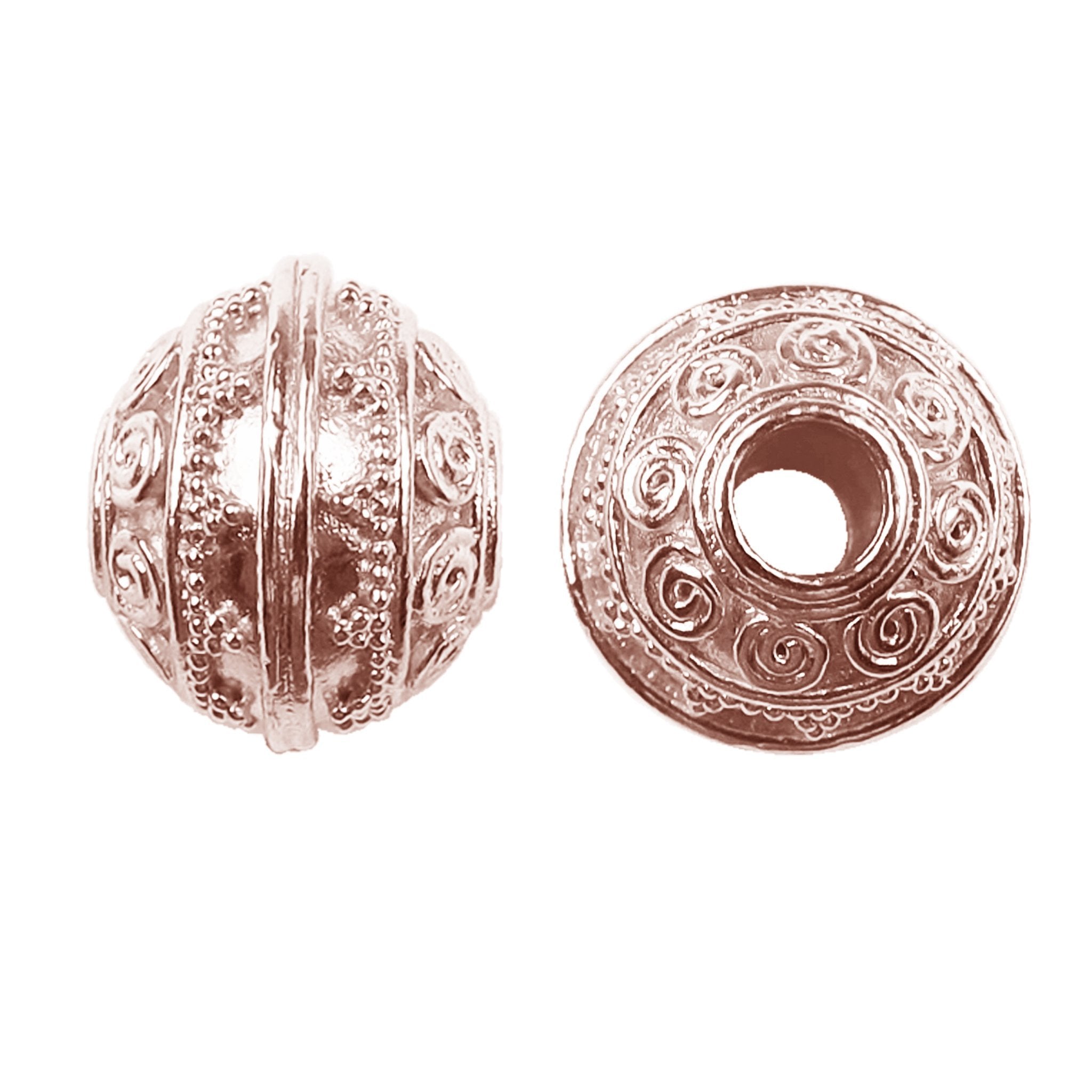 Decorative round spacer bead with spiral scroll design in rose gold overlay over copper, handcrafted in India