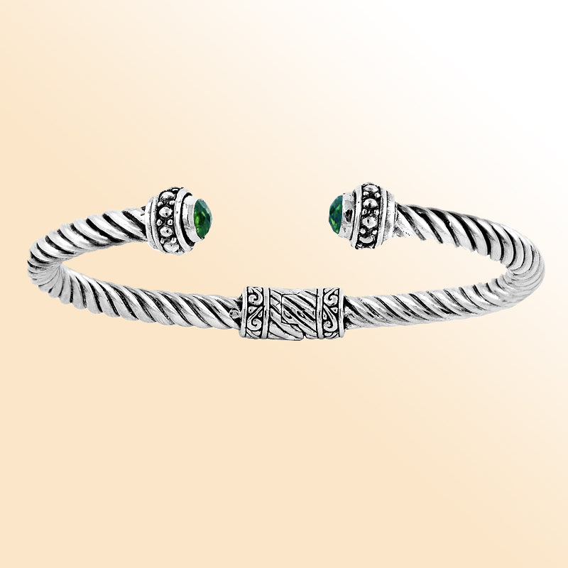 Handcrafted silver cuff bracelet with green quartz stones in twisted rope Bali design.