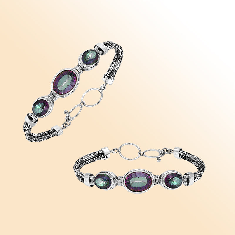 Handcrafted silver bracelet with mystic quartz stones in woven Bali design.
