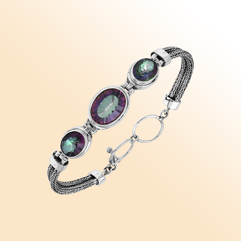 Handcrafted silver bracelet with mystic quartz stones in woven Bali design.