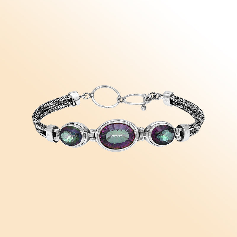 Handcrafted silver bracelet with mystic quartz stones in woven Bali design.