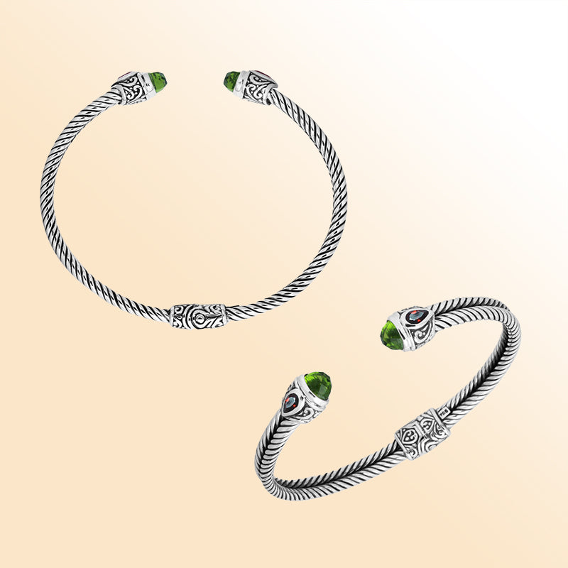 Handcrafted silver cuff bracelet with peridot quartz ends and garnet quartz accents in Bali design.