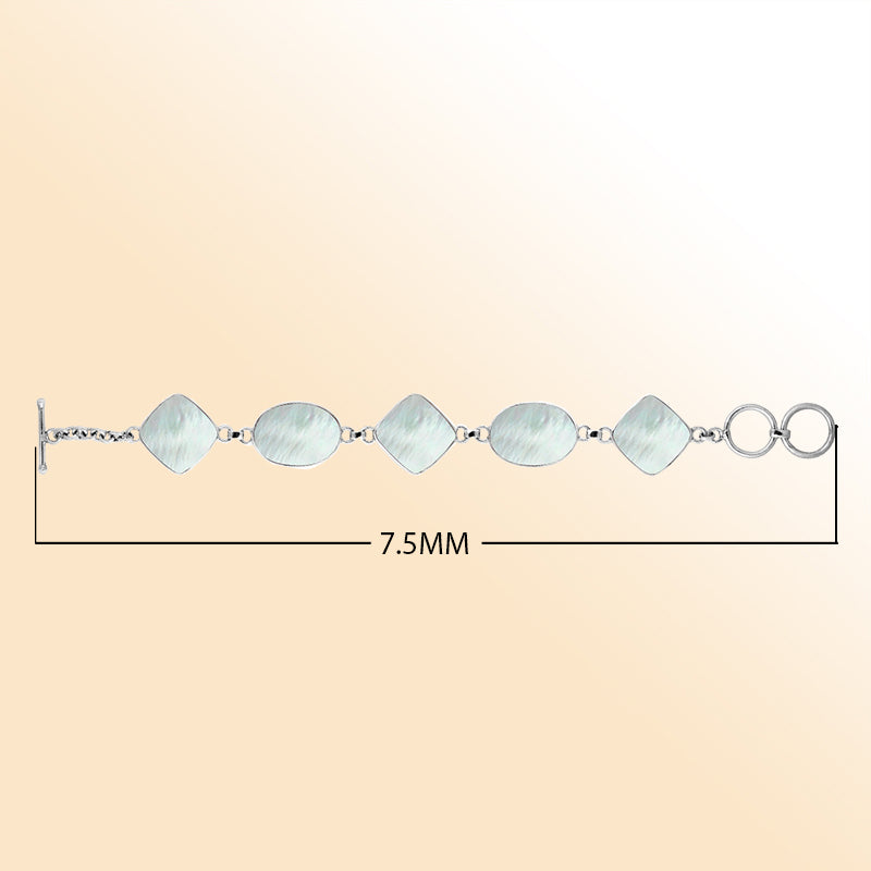 Handcrafted silver bracelet with oval and cushion mother of pearl links, elegant artisan design.