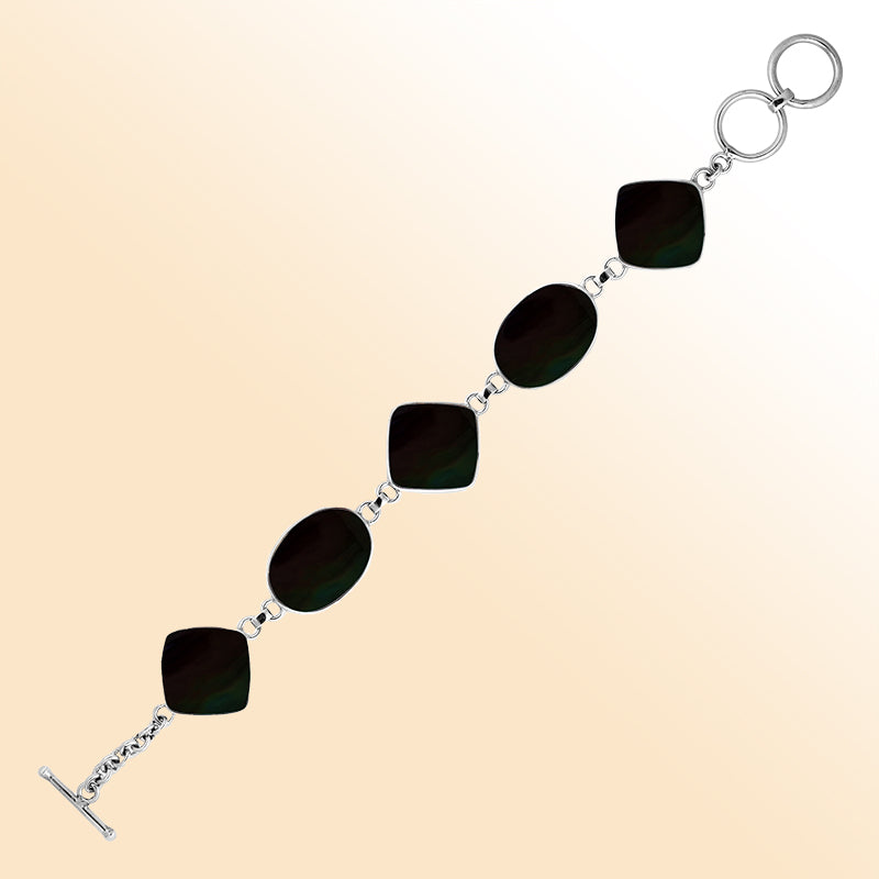 Handcrafted silver bracelet with alternating oval and cushion black shell links, elegant design.