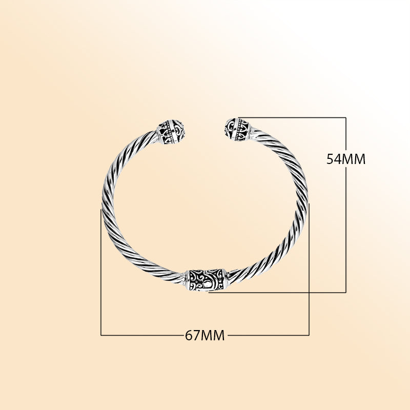 Sterling silver cuff bangle with twisted rope design and intricate Balinese end motifs, handmade in Bali.