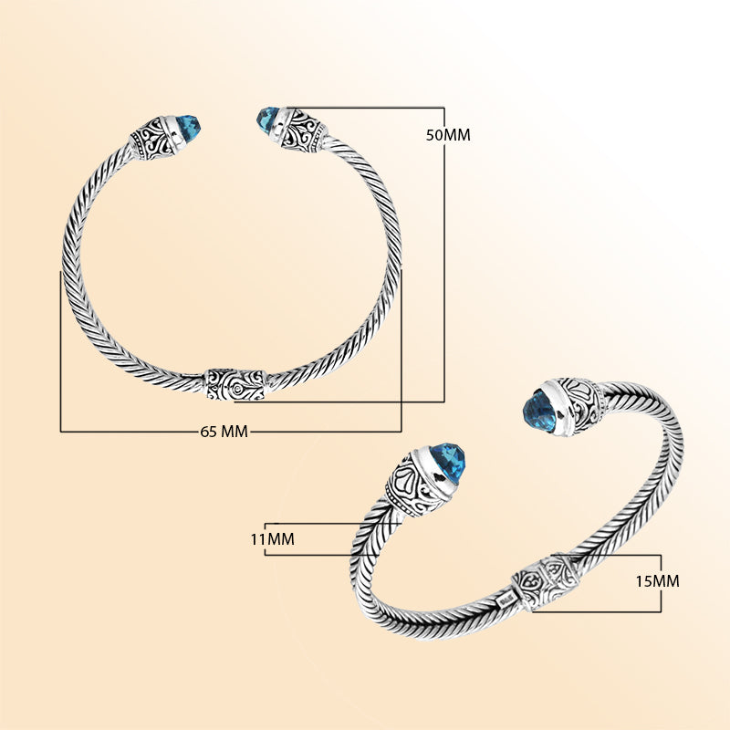 Sterling silver wholesale bangle with twisted rope design, accented by Blue Topaz Quartz and Balinese handcrafted motifs.