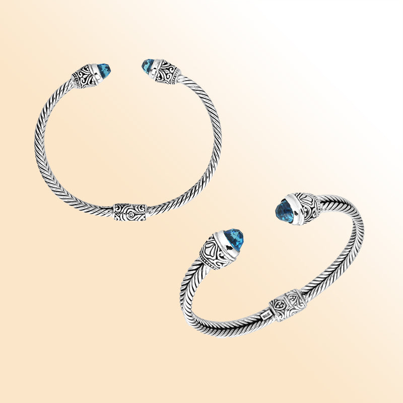 Sterling silver wholesale bangle with twisted rope design, accented by Blue Topaz Quartz and Balinese handcrafted motifs.