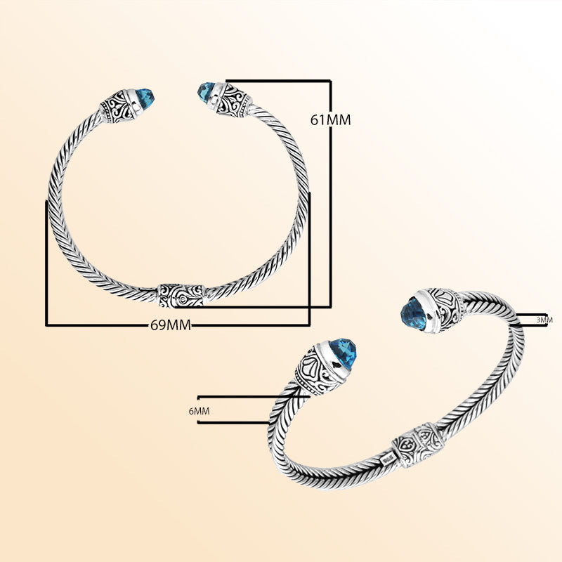 Sterling silver wholesale bangle with twisted rope design, accented by Blue Topaz Quartz and Balinese handcrafted motifs.