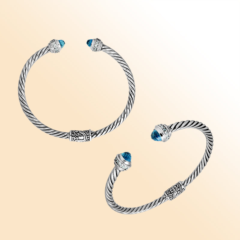 Handcrafted Bali sterling silver bangle featuring Blue Topaz Quartz and Cubic Zirconia, rope-style design with ornate motifs.