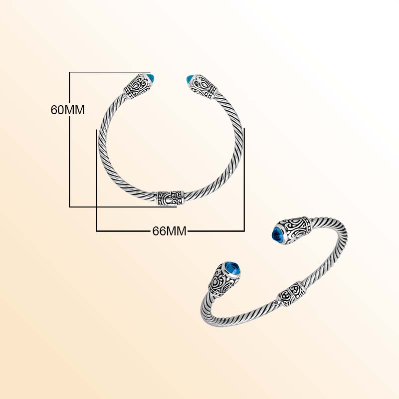 Handmade silver bangle with blue topaz quartz ends and Balinese carved design