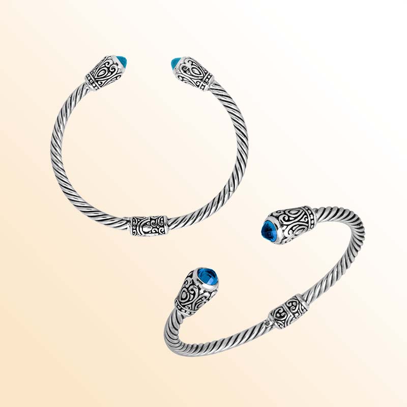 Handmade silver bangle with blue topaz quartz ends and Balinese carved design
