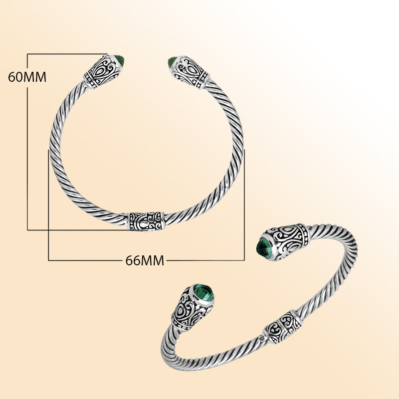 Handmade silver bangle with green quartz ends and Balinese carved design