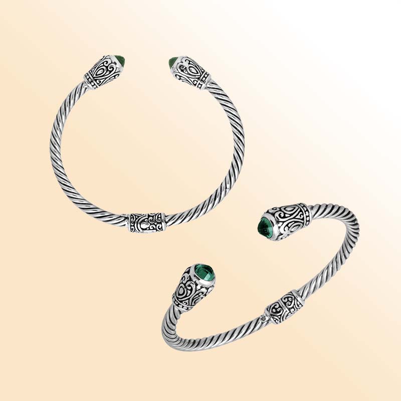 Handmade silver bangle with green quartz ends and Balinese carved design