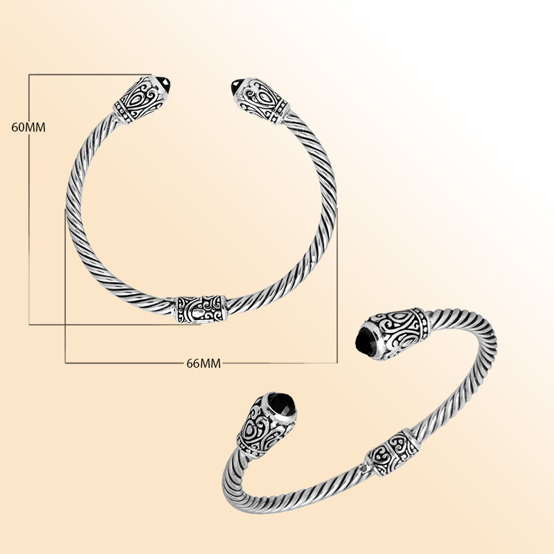 Handmade silver bangle with black onyx ends and Balinese carved design