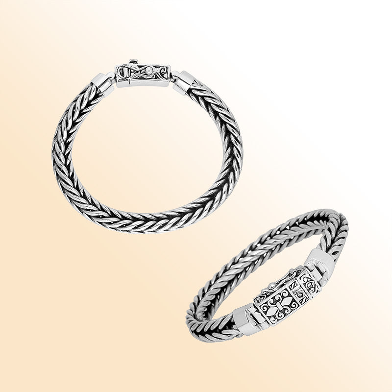 Sterling silver double-braided bracelet with ornamental engraved clasp shown in two angles on white background.