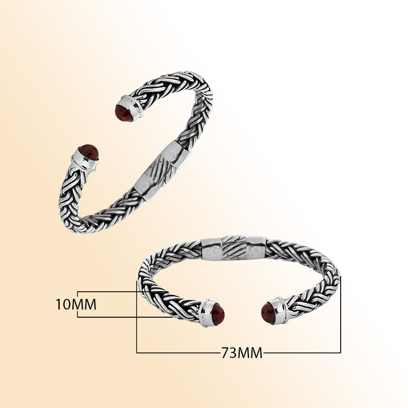 Handcrafted sterling silver bangle with Coral stones in Balinese braided design.