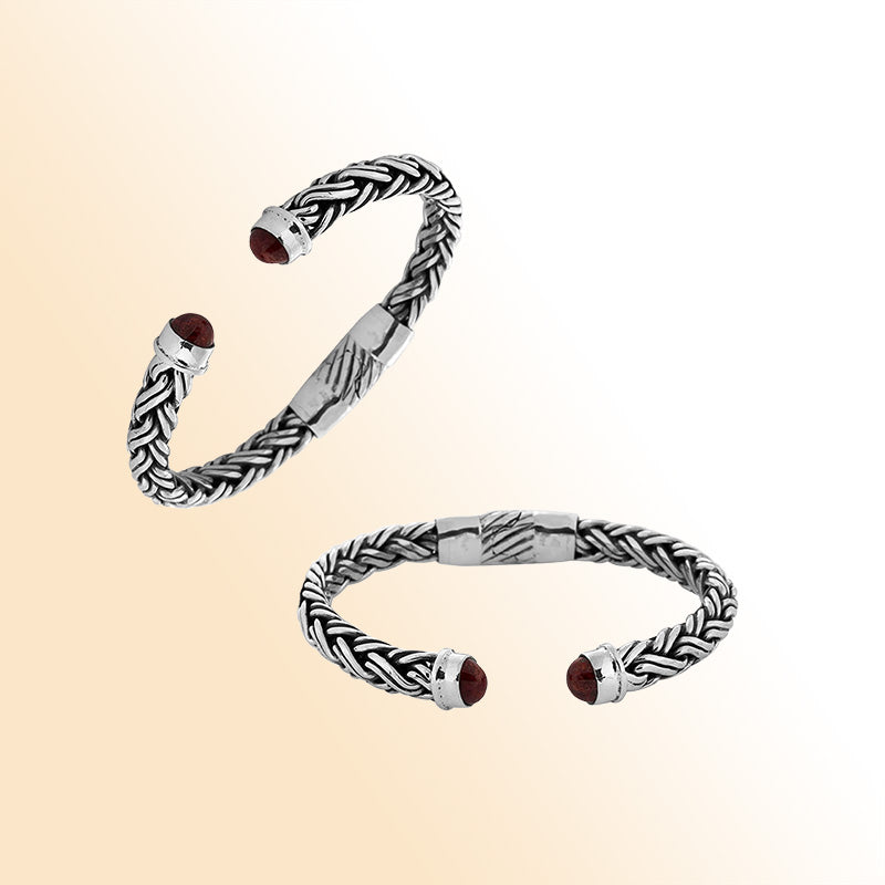 Handcrafted sterling silver bangle with Coral stones in Balinese braided design.