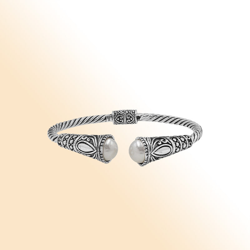 Elegant sterling silver open bangle with pearl accents and detailed Balinese pattern