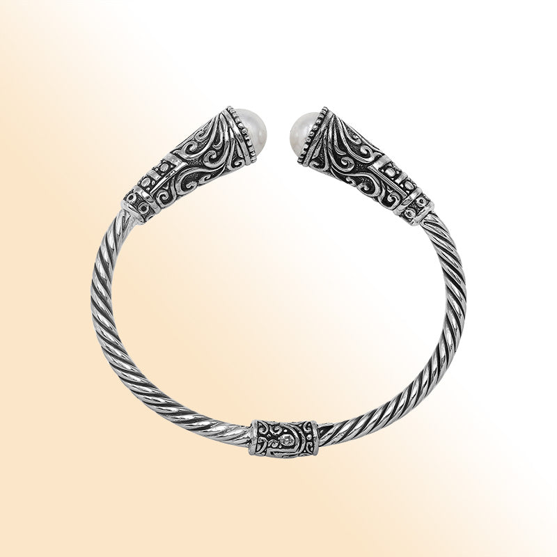 Elegant sterling silver open bangle with pearl accents and detailed Balinese pattern