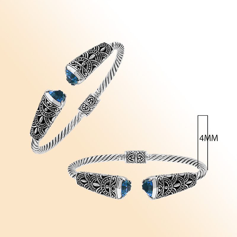 Elegant sterling silver open bangle with blue topaz quartz accents and Balinese detailing