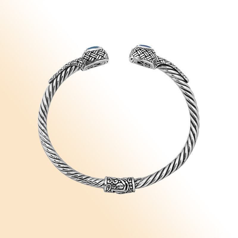 Elegant sterling silver braided bangle with blue topaz quartz accents and intricate Balinese pattern
