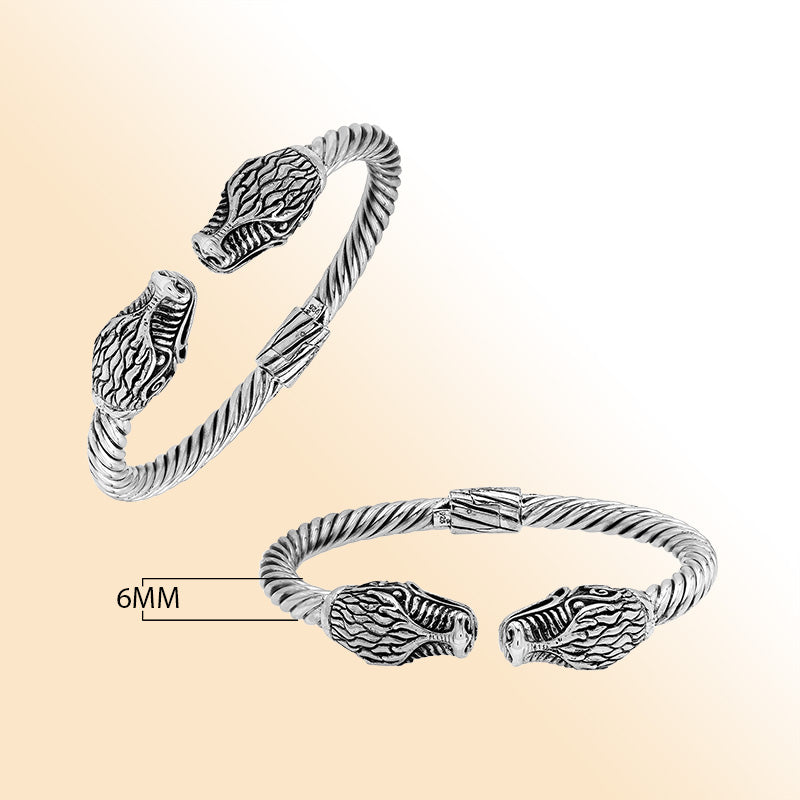 Sterling silver open bangle with dragon head motifs and twisted Balinese design