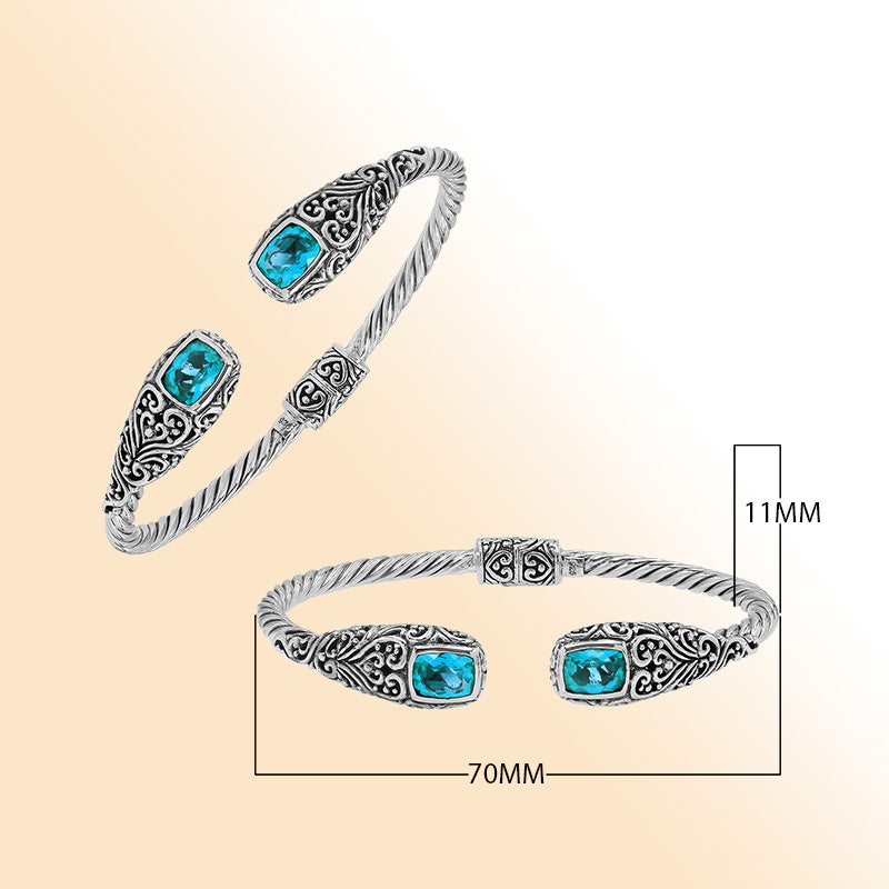 Elegant sterling silver open bangle with blue topaz quartz accents and Balinese engraved pattern