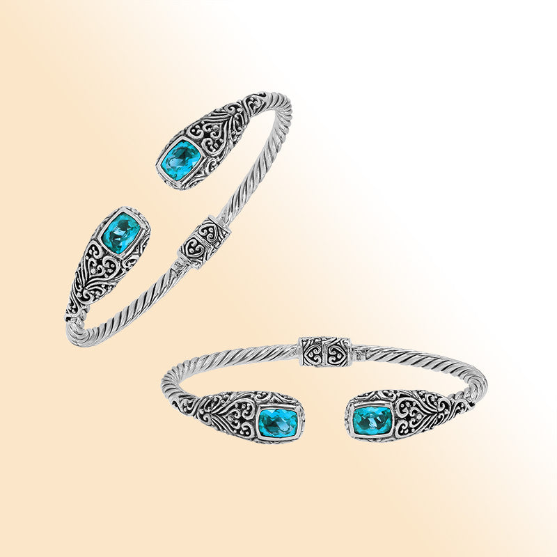 Elegant sterling silver open bangle with blue topaz quartz accents and Balinese engraved pattern