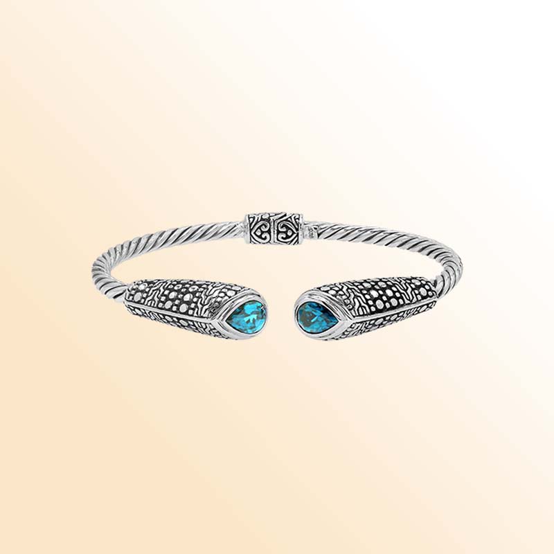 Elegant sterling silver open bangle with blue topaz quartz accents and Balinese dot design