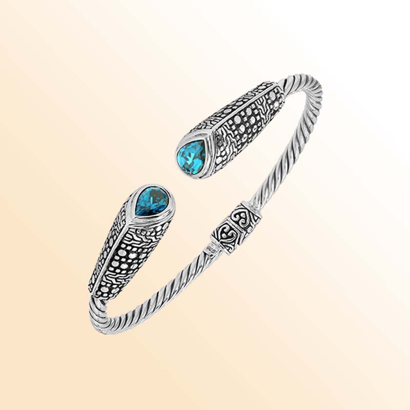 Elegant sterling silver open bangle with blue topaz quartz accents and Balinese dot design
