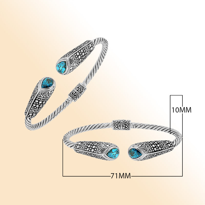 Elegant sterling silver open bangle with blue topaz quartz accents and Balinese dot design