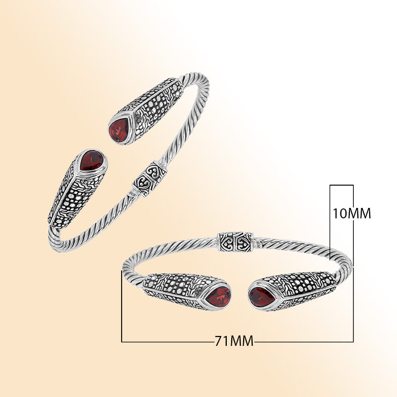 Elegant sterling silver open bangle with garnet quartz accents and Balinese dot design