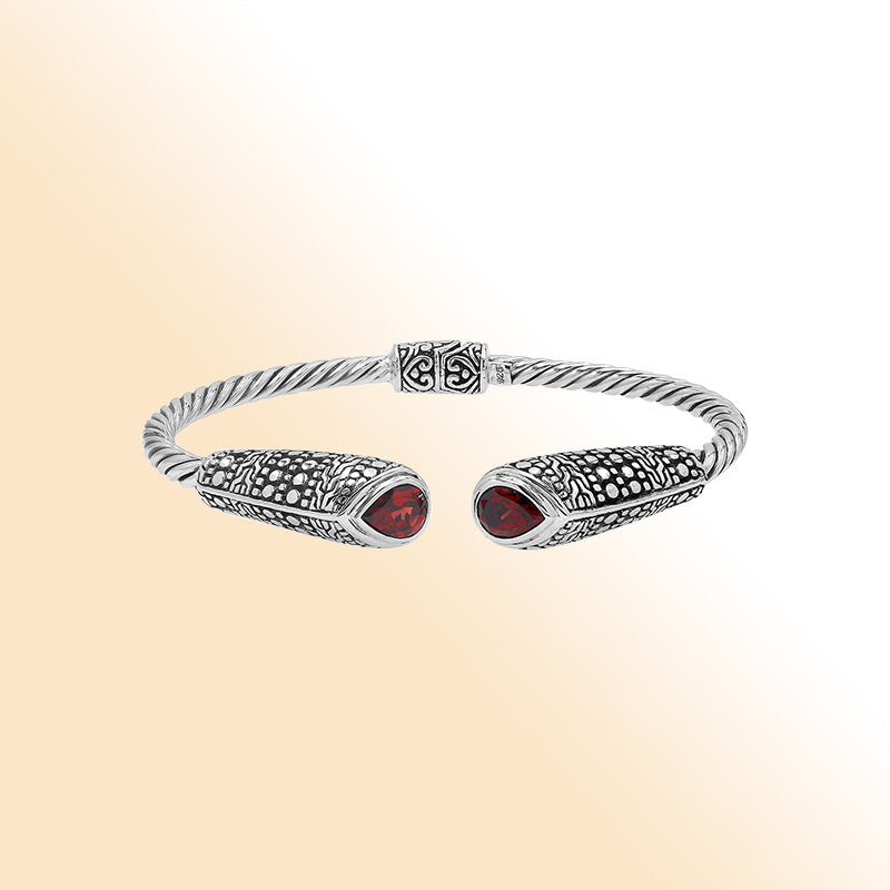 Elegant sterling silver open bangle with garnet quartz accents and Balinese dot design