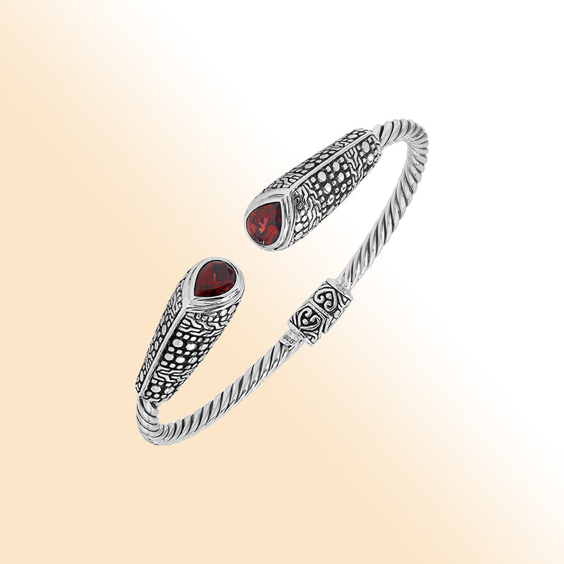 Elegant sterling silver open bangle with garnet quartz accents and Balinese dot design