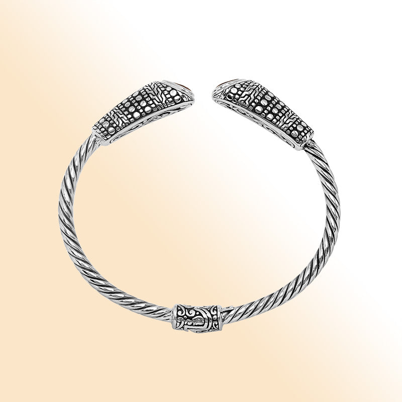 Elegant sterling silver open bangle with garnet quartz accents and Balinese dot design