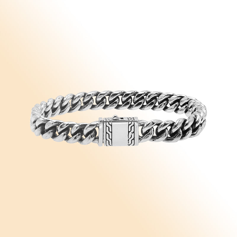 Elegant sterling silver Cuban chain bracelet with polished links and engraved clasp