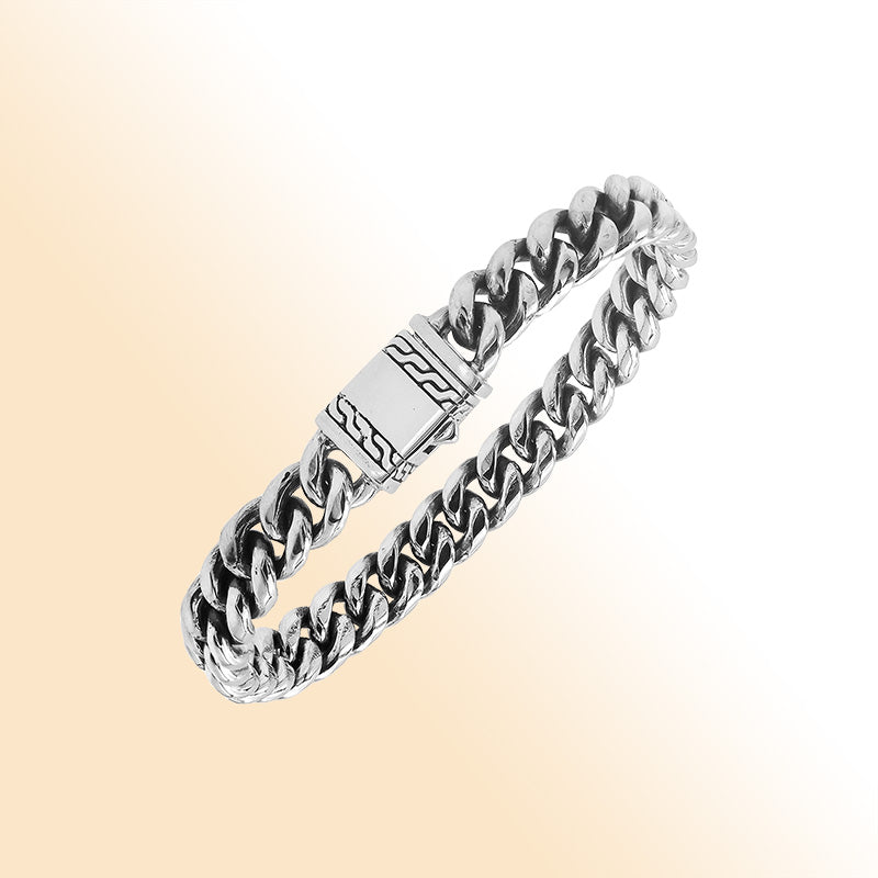 Elegant sterling silver Cuban chain bracelet with polished links and engraved clasp
