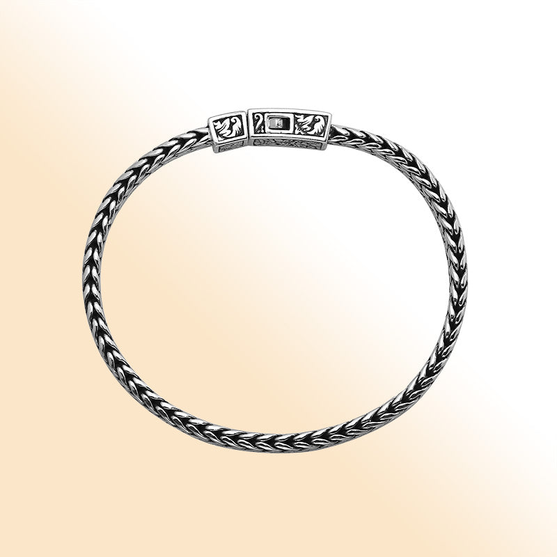 Sterling silver woven bracelet with geometric Balinese clasp and oxidized finish