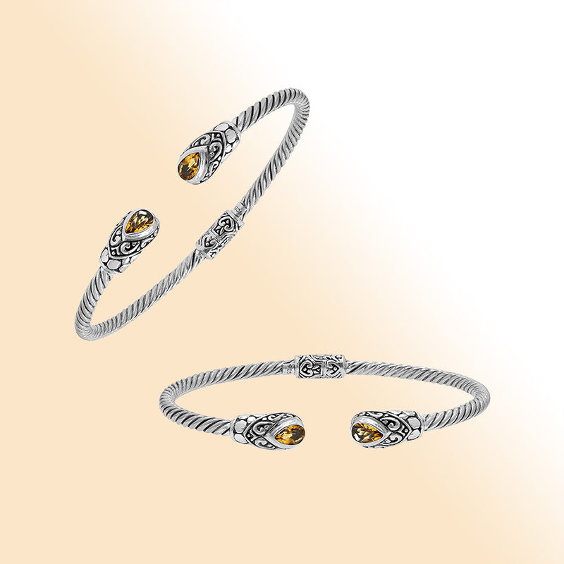 Elegant sterling silver open bangle with citrine quartz teardrop stones from India.