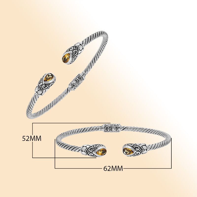 Elegant sterling silver open bangle with citrine quartz teardrop stones from India.