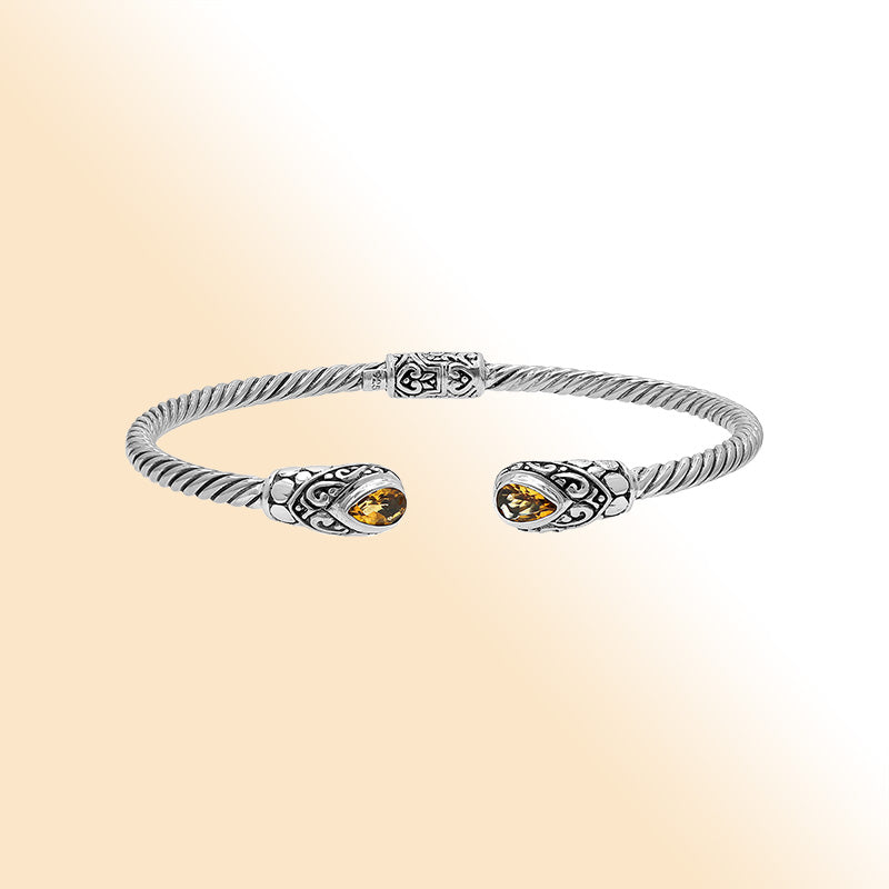 Elegant sterling silver open bangle with citrine quartz teardrop stones from India.