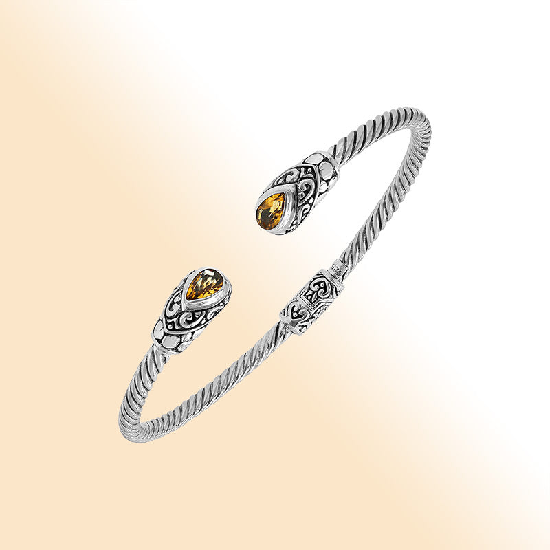 Elegant sterling silver open bangle with citrine quartz teardrop stones from India.