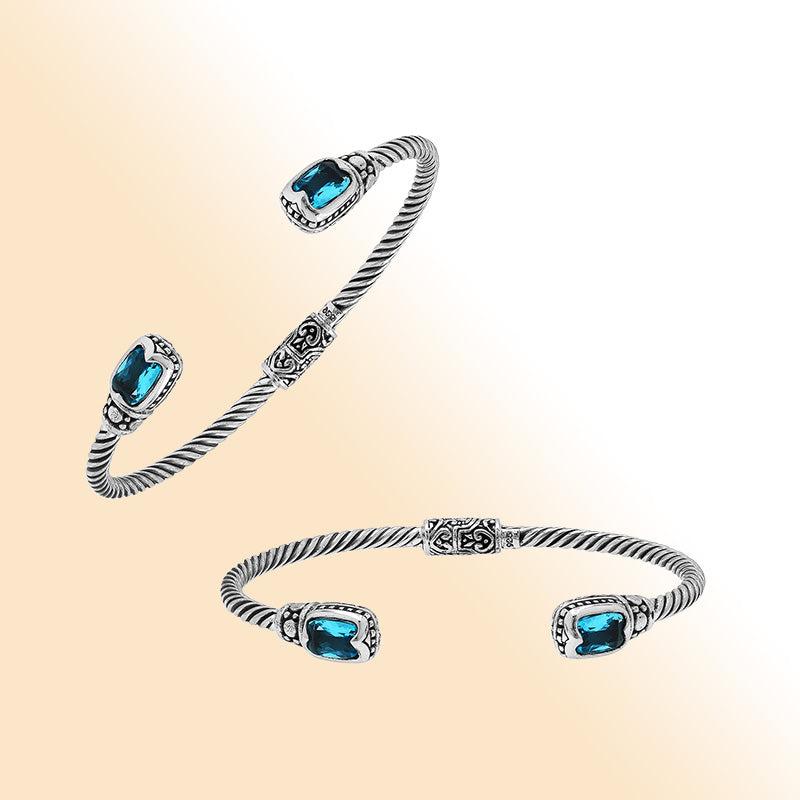 Sterling silver Balinese cuff bangle with Blue Topaz Quartz accents and intricate scroll design.