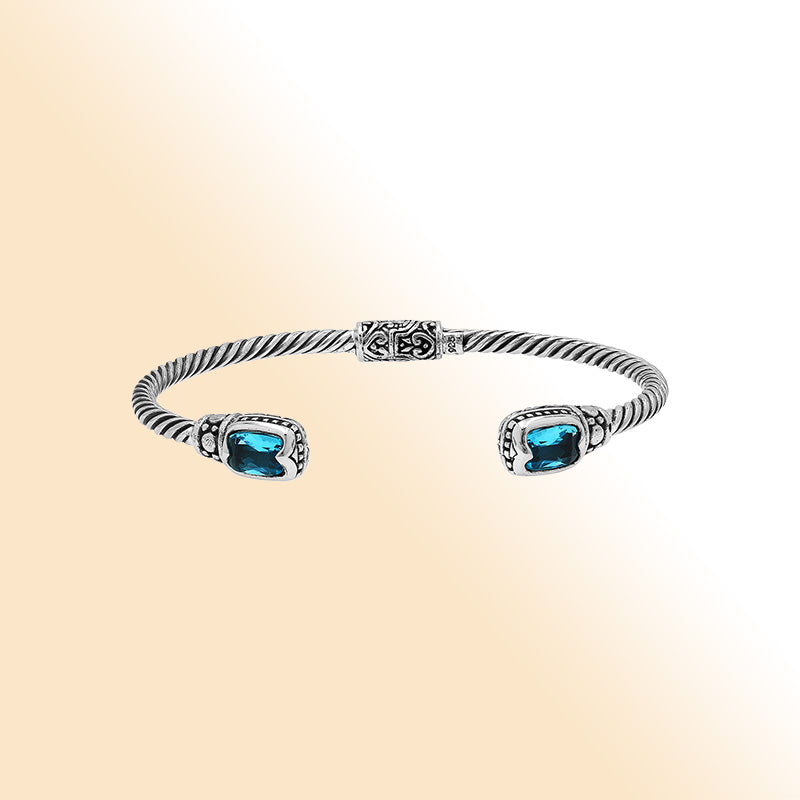 Sterling silver Balinese cuff bangle with Blue Topaz Quartz accents and intricate scroll design.